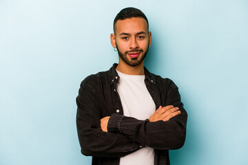 Wall Mural - Young hispanic man isolated on blue background happy, smiling and cheerful.