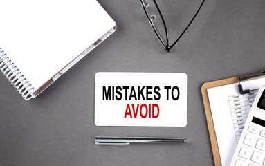 Poster - MISTAKES TO AVOID Text written on the card with notebook and clipboard, grey background