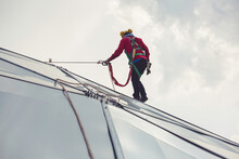 Male workers rope access height safety connecting with eight knots safety harness construction site oil tank dome.