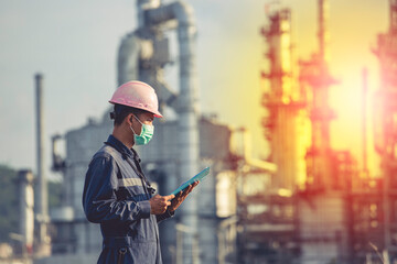 Wall Mural - Male workers do inspection and record process refinery at industrial construction site oil and gas.