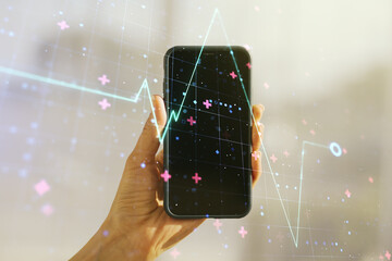 Poster - Double exposure of creative abstract heart rate hologram and hand with cell phone on background. Healthcare technolody concept