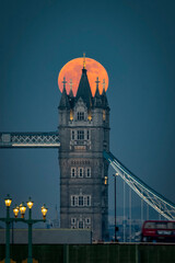 Wall Mural - A big, red full moon rise behind the Tower Bridge of London, England during dusk