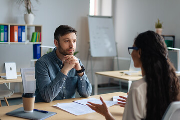 Poster - Focused personnel manager and young female job applicant communicarting on work interview at modern company office