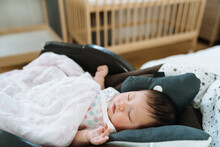 Closeup Shot Innocent Baby Sleeping Peacefully In Bouncer Chair. Daytime Female Newborn Napping Alone With Blurred Background.