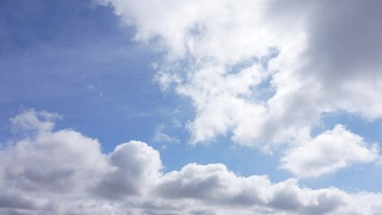 Wall Mural - beautiful morning sunny clear blue sky with small fluffy white clouds flying overhead in clear blue 