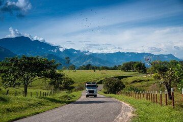 Wall Mural - Freight truck on a country road in a tropical landscape with mountains. Colombia.