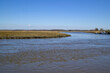 Tidal estuary flowing to the Delaware Bay. Also known as a coastal salt marsh or tidal marsh it is home to blue crabs which are an economically important marine shellfish.