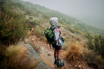 Come rain or sunshine, I always make time for hiking. Shot of a woman wearing her rain jacket while out hiking.