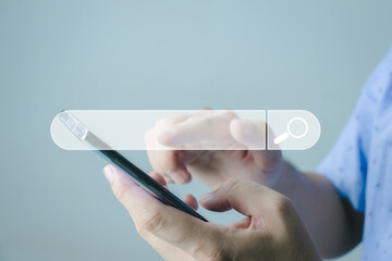Wall Mural - The concept of using technology to search for information, a man's hand is using a smartphone to search for information on social media via the Internet online.