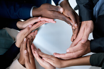Poster - Anything can be achieved if we work together. Cropped shot of a group of unrecognizable businesspeople joining their hands in solidarity.