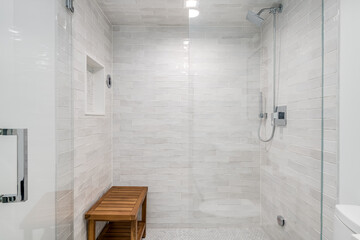 Wall Mural - Modern Glass Shower with Bamboo Bench. White and gray tiled shower enclosure with glass doors and bamboo bench.