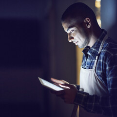 Aufkleber - Its never to late to succeed. Shot of a young man working late on a digital tablet in his coffee shop.