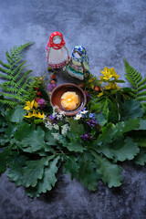 Sticker - wiccan altar with witchcraft folk dolls, candle, flowers, oak and fern leaves on dark abstract background. Witchcraft Esoteric pagan Ritual. summer solstice, Litha pagan holiday.