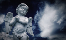 Little Guardian Angel Against Blue Sky. Copy Space For Design.