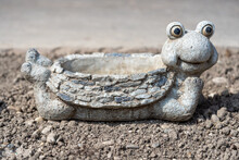 Lovely Frog Pot Made Of Stone In The Garden On A Sunny Day