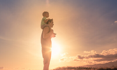 Wall Mural - Father son adventure. Little boy and his dad outdoors enjoying the beautiful sunrise. Happy active family lifestyle concept. 