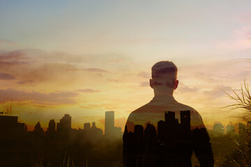 Young man with a vision looking at the city from afar. double exposure 