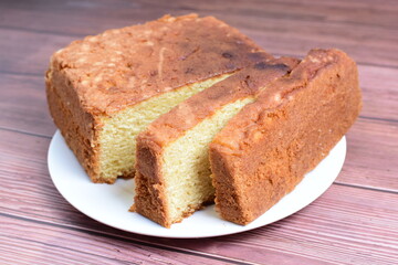 Canvas Print - Homemade vanilla cake, displayed on plate and wooden background