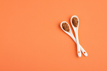 Sticker - Crushed flax seeds in two ceramic spoons - Linum usitatissimum