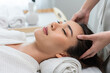 © Kawee - Asian young woman feel happy and relax during facial and head massage.