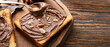 © Pixel-Shot - Board with fresh bread and chocolate nut butter on wooden background with space for text