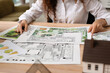 © Pixel-Shot - Young female landscape designer working in office