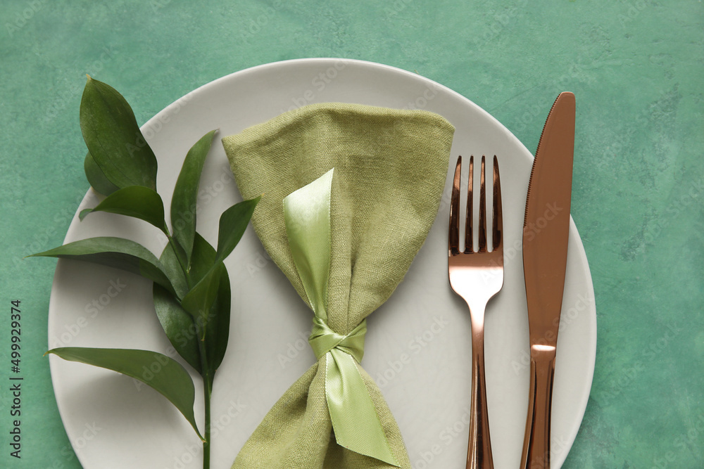 Elegant table setting on green background
