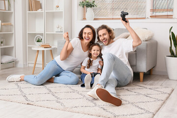 Wall Mural - Young family playing video games at home