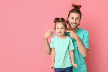 Poster - Funny man and her little daughter on pink background. April fools' day celebration