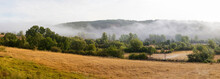 Low Fog In Beautiful Landscape Of Meadows With Trees And Hedges Between Summer And Autumn 