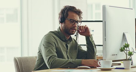 Aufkleber - Music makes me work more effectively. 4k video footage of a cheerful young businessman working on his computer while listening to music through his headphones in the office.