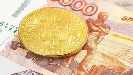 Wall Mural - Bitcoin coins (new virtual money) on Russian banknotes A close up image of bitcoins with Russian rubles banknotes Bitcoin coin on the background of Russian rubles Bitcoin Russia Ruble Cryptocurrency