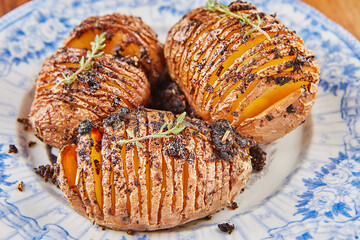 Poster - Hedgehog Potatoes with Provence herbs on plate. French gourmet cuisine