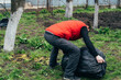 © Anastasia - A man removes a large bag of garbage