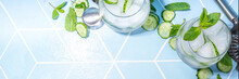Refreshing Summer Drink - Detox Mint, Cucumber, Lemon Cocktail. On Light Blue Tiled Table, Bright Sunlight, Copy Space. Two Glass With Cucumber Infused Water Or Lemonade, Healthy Diet Drink