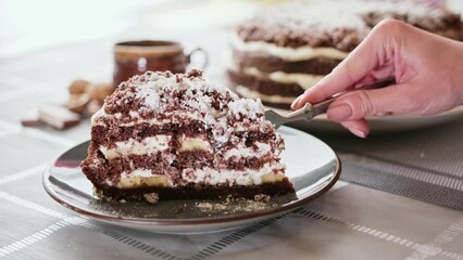 Wall Mural - Hungry woman cut out slice from homemade chocolate cake