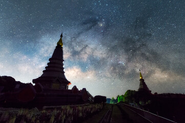 Wall Mural - the milky way galaxy moving over a sacred temple at doi inthanon national park, chiang mai, thailand