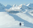Alpinist walking on snow in the mountains