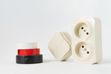 Multicolored Insulating Tape, Double Socket And Two-key Light Switch On White Background. Mechanical Device For Switching Lighting Circuit, Two Sockets Connected By Monolithic Case. Electronic Devices