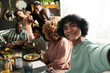 © AnnaStills - Teenage boy making selfie portrait of his big family during holiday dinner at table