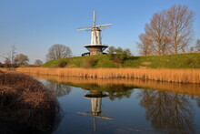Reflections Of A Traditional Windmill In The Colorful Countryside Surrounding Veere, Zeeland, Netherlands