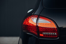 Modern Car Rear Taillight Lamp Close Up View. Clean Trunk Of Modern SUV Car