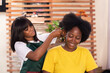 african lady having her hair done in a salon