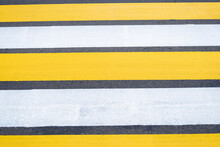 Yellow-white Pedestrian Crossing On Asphalt. Close-up Of The Road.
