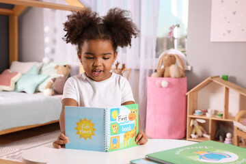 Sticker - African American girl reading book at home