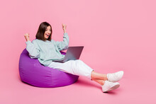 Full Body Photo Of Hooray Bob Hairstyle Young Lady Sit Look Laptop Wear Hoodie Pants Sneakers Isolated On Pink Background