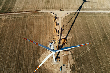 Canvas Print - Installing new wind generator, Windmill turbine maintenance, Construction site with cranes for installing windmill tower, Wind power and renewable energy