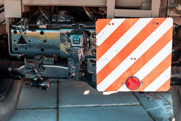 A sign on the trailer of a truck about bulky and oversized and dangerous cargo