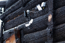 Safety System. Sensors And Wires On The Outer Wall. Fragment Of A Burnt Log Hut. After The Fire. Texture Of Charred Wood. Selective Focus