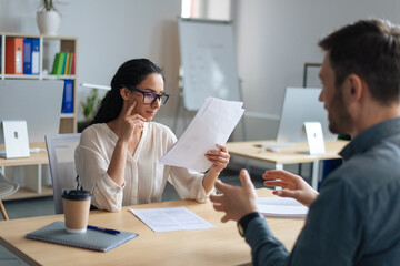 Poster - Personnel manager communicating with vacancy candidate, reading resume during job interview at office